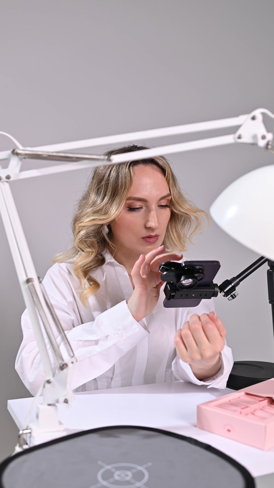 Salome shooting nail content on an iPhone with a professional lighting setup
