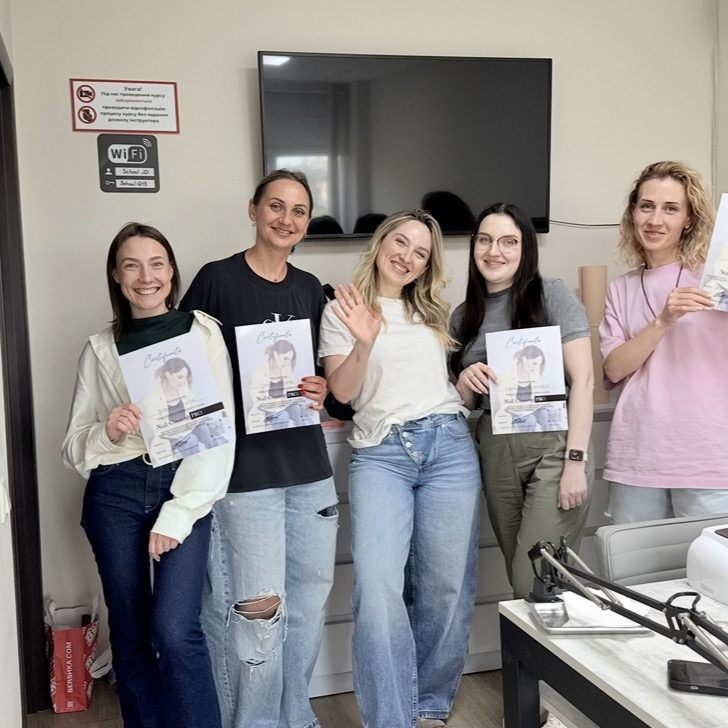 Students holding certificates after an offline FOCUS UP course